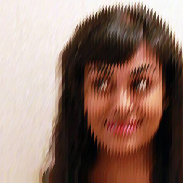An image of a young woman from the shoulders up. She has brown skin and long black hair, and she's looking to the side and smiling slightly. There is a filter applied to the image that pixelates it and distorts it slightly; the image appears to be constructed of overlapping circles in the colors of the photo.
