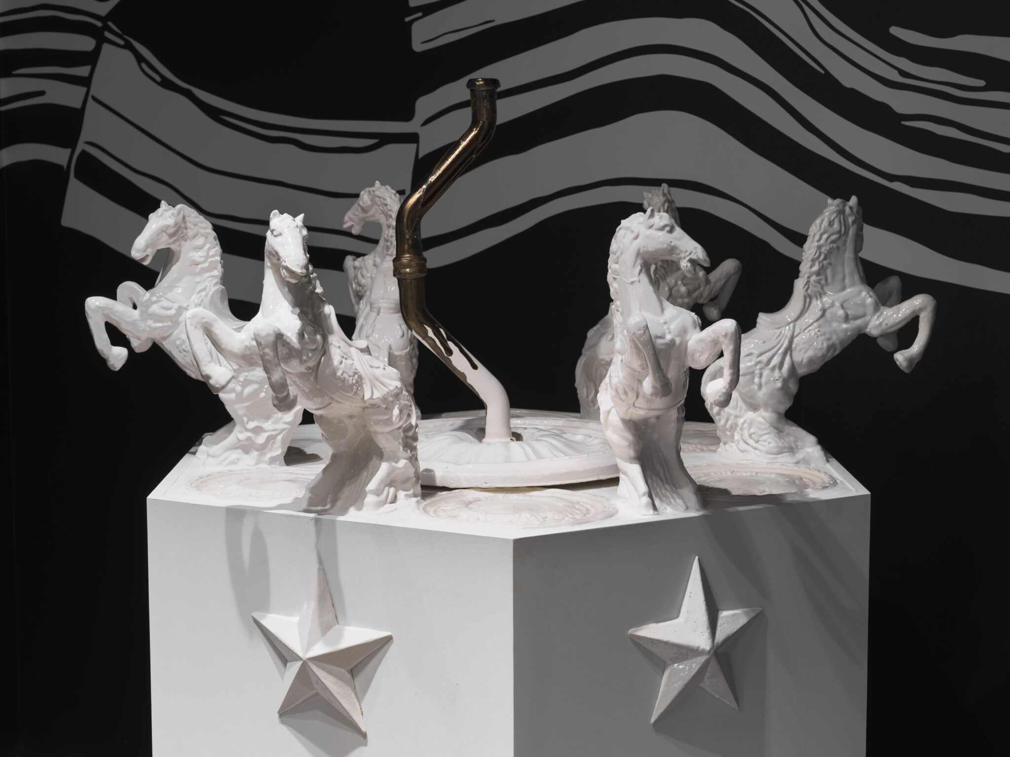 Inspired by the architecture of Bahria Town's real estate developments, I created a distorted ceramic replica (pirated copy) of the monumental fountains at the centers of hyper-manicured roundabouts. My version of the Gorah ki chowk (horse roundabout) sits atop a hexagonal column, embedded with ceramic stars, all in pristine white, evoking the image of an ivory tower. I used AR to animate the fountain by scanning plastic bags that I found around the development in Lahore, to create the texture of water flowing out of the QR-code-horse-lined fountain on screen.
