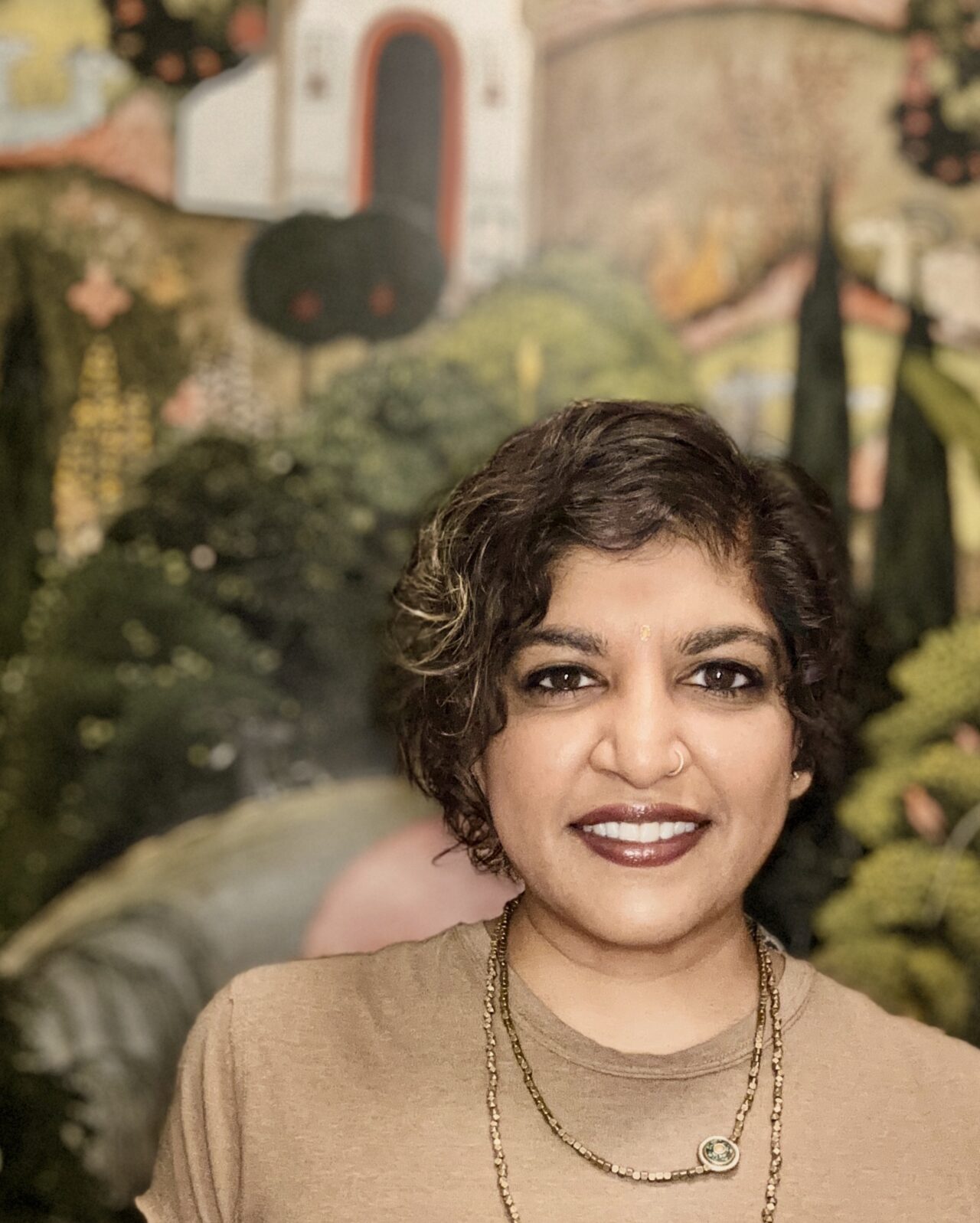 Portrait of Sheetal Prajapati. She is a first generation Indian American. She has shorter, neck length, curly, dark-brown hair.