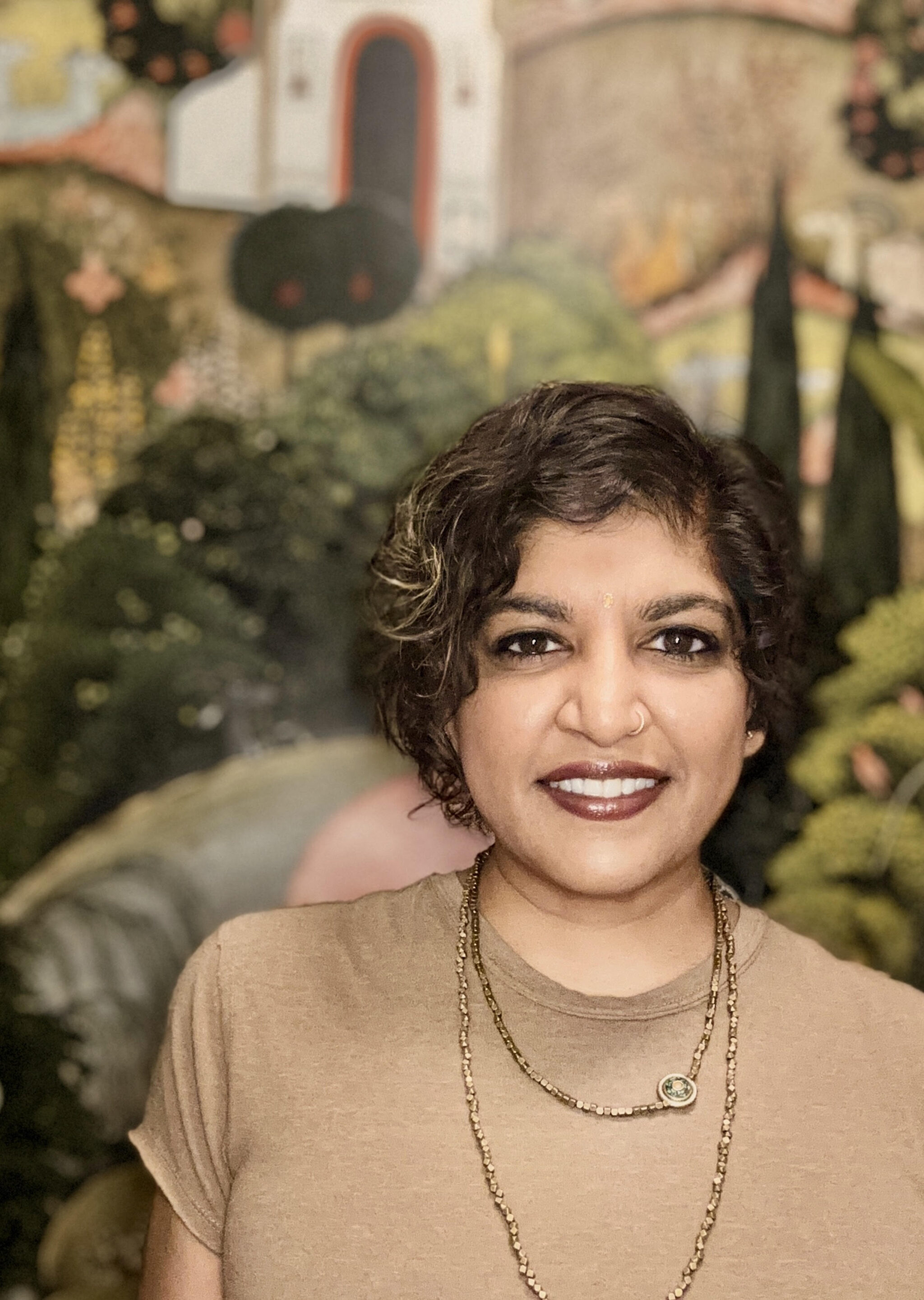 Portrait of Sheetal Prajapati. She is a first generation Indian American. She has shorter, neck length, curly, dark-brown hair.